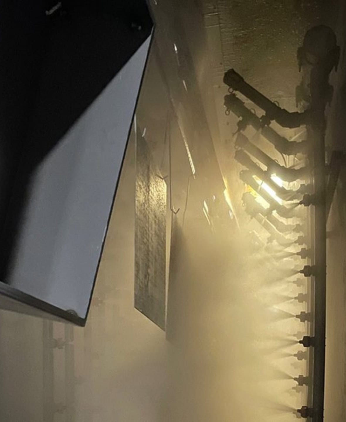 Application of a cleaner/conversion coating in a recirculating spray washer.